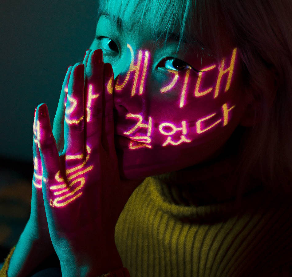 Person beside multicolor neon typography